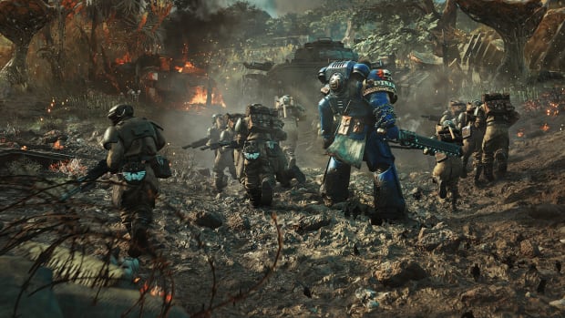 Warhammer 40,000: Space Marine 2 screenshot of soldiers advancing over mud.