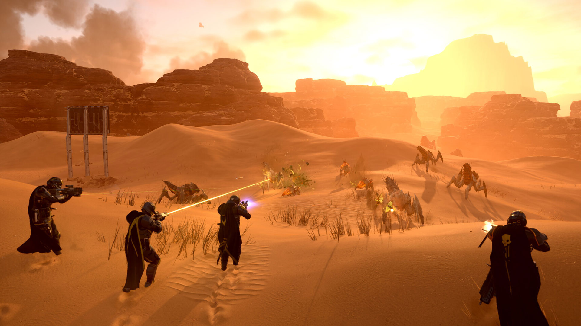 A squad of Helldivers 2 soldiers shooting bugs in the desert.